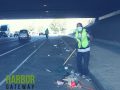 person sweeping under a freeway